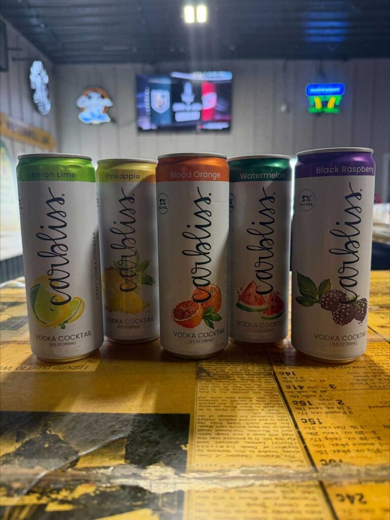 Five Carbliss vodka cocktail cans at The Dirty Turtle Bar, ready for drinks with friends.